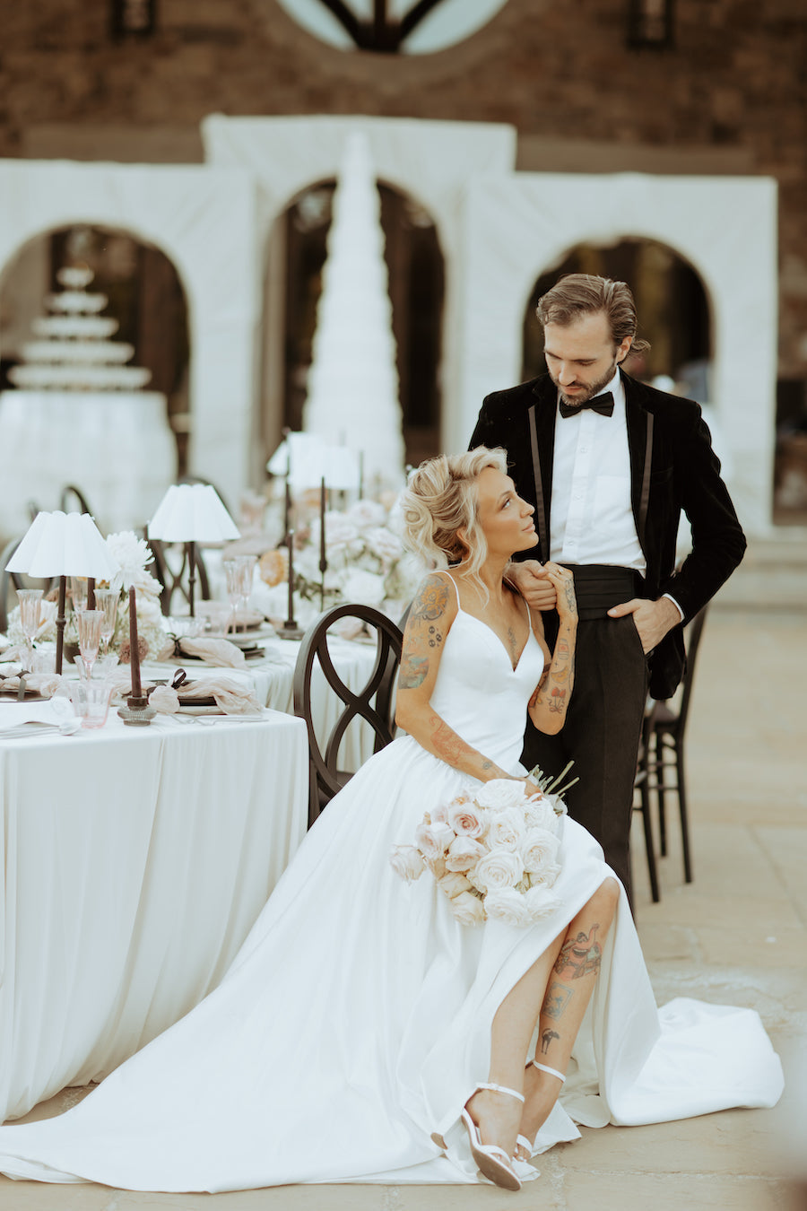 Bride and groom at a black-tie garden wedding reception table at Chateau de Lis in Oregon
