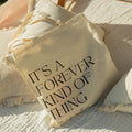 Personalized wedding favor tote bag in natural cotton canvas with custom text and ribbon