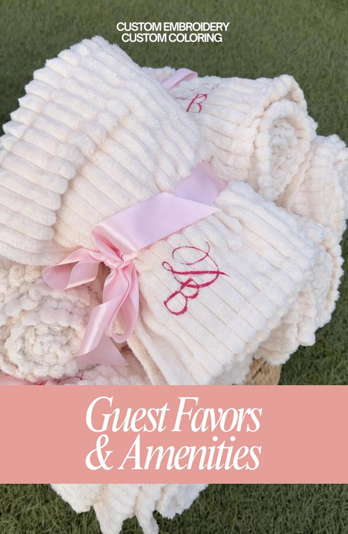 Cream ribbed wedding guest blanket with custom embroidery, tied with a light pink satin ribbon